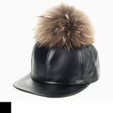 black cap with faux fur pom pom